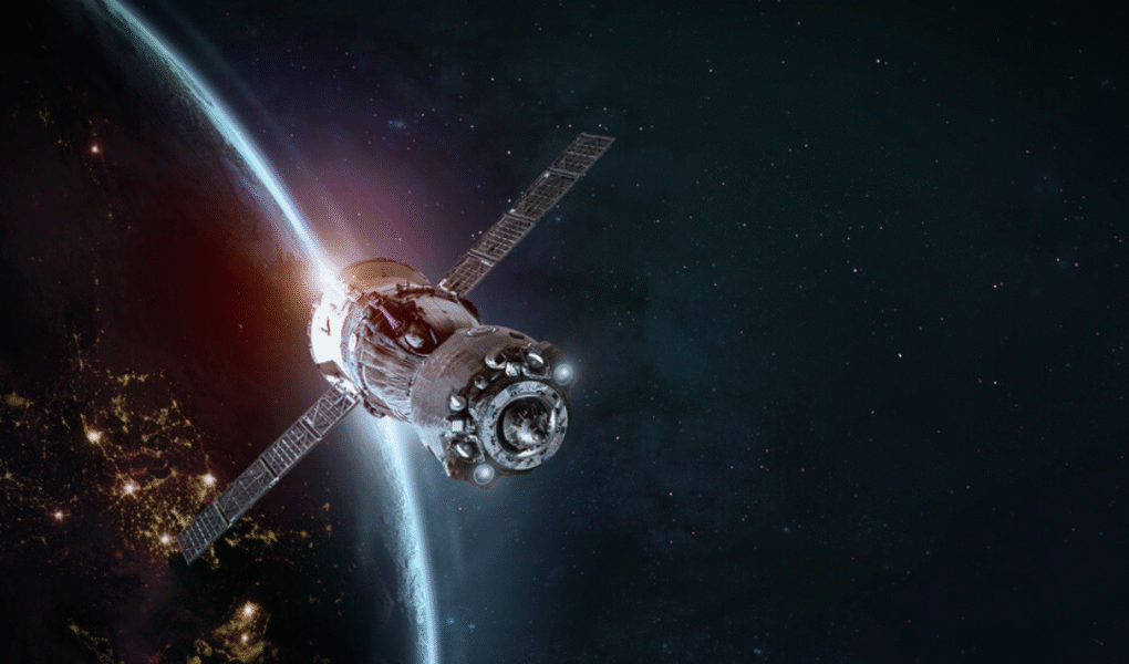 Artificial satellite orbiting Earth with visible solar panels and atmospheric glow in the background, representing advanced space technology.