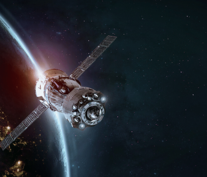 Artificial satellite orbiting Earth with visible solar panels and atmospheric glow in the background, representing advanced space technology.