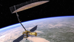 Illustration of the NISAR satellite in orbit above Earth, showing its large radar antenna designed for high-resolution Earth surface monitoring under NASA-ISRO collaboration.