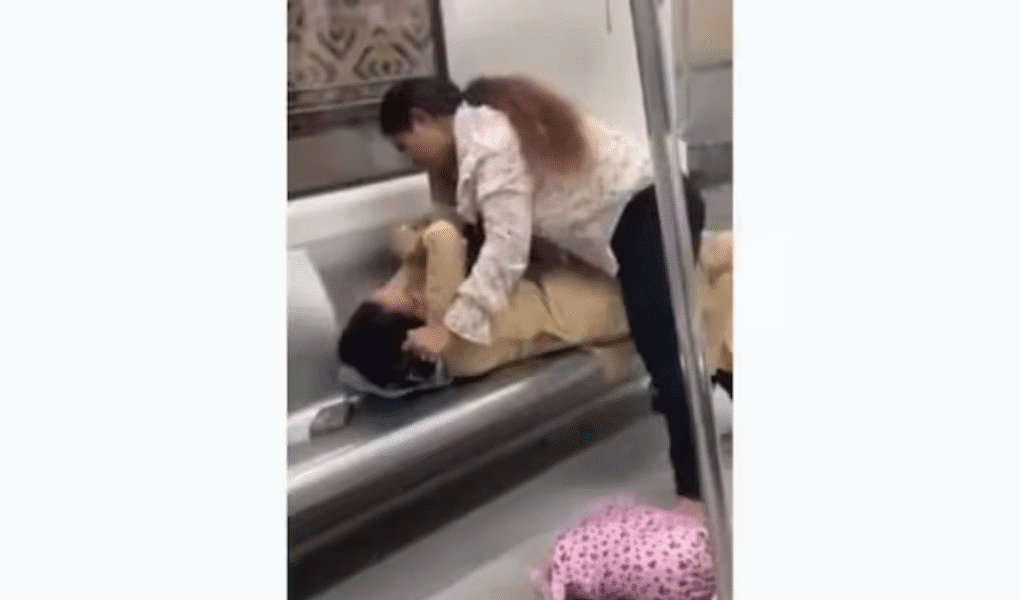 Viral news video shows two women slapping and pulling hair in a Delhi Metro coach during a fight over a seat, leaving passengers shocked.