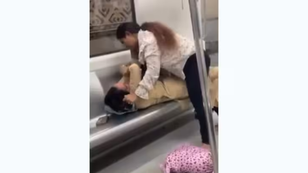 Viral news video shows two women slapping and pulling hair in a Delhi Metro coach during a fight over a seat, leaving passengers shocked.
