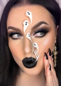 Glamorous halloween makeup design with silver eyeshadow and dark contouring for a haunted look.