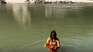 foreign tourist taking a dip in the Ganga wearing a bikini