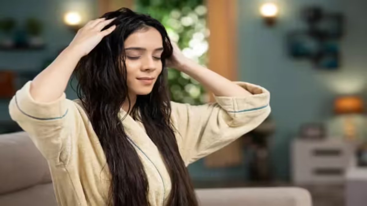 A girl applying homemade hair oil for dandruff and rough hair