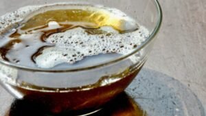 Homemade herbal hair oil in a glass bowl