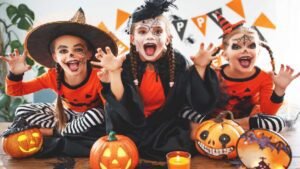 Kids in spooky costumes smiling with pumpkins – what is Halloween celebration
