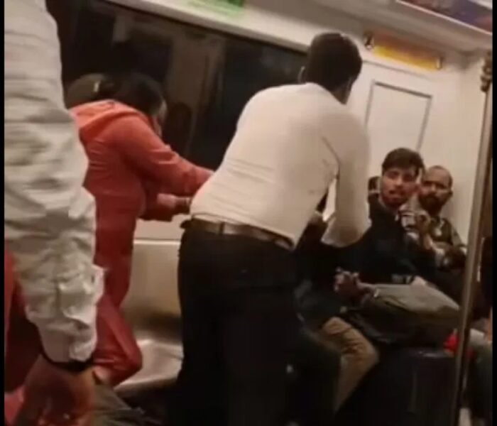 Viral video shows two passengers fighting inside a crowded Delhi Metro coach as shocked commuters look on.