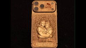 Close-up of the highly customized, gold-plated 'Jai Shri Ram' iPhone 17 Pro Max, showing the detailed carvings of Lord Ram and Lord Hanuman that made the ₹50 lakh phone **viral** online.