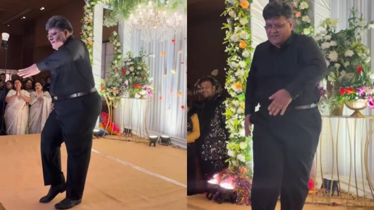 An elderly father dressed in all black performing a humorous slow-motion dance on stage at his daughter's Sangeet ceremony, the moment captured in a viral **Video** clip.