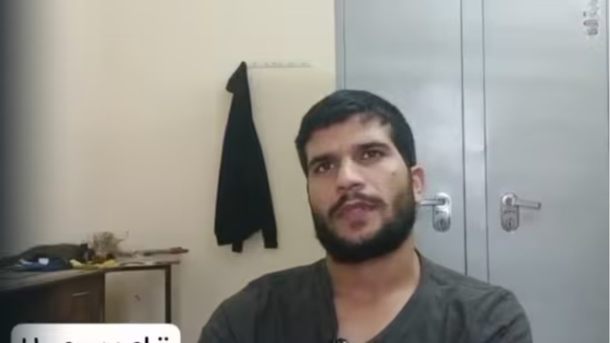 Close-up video still of **Umar un Nabi**, the alleged Delhi bomber, speaking in a room with a metal cupboard and a hanging jacket, discussing his extreme views on suicide bombings.