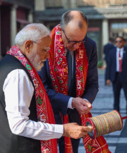 PM Modi teaching German Chancellor Friedrich Merz kite flying techniques at International Kite Festival Ahmedabad